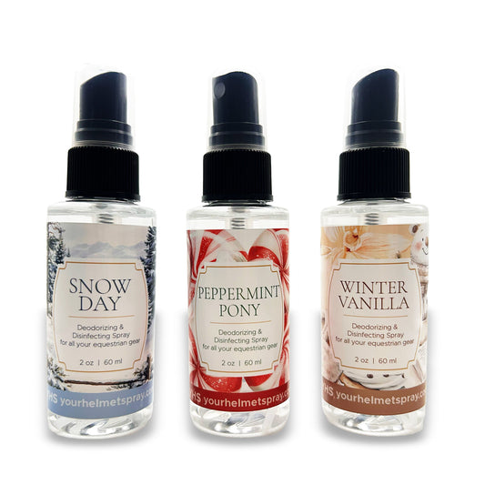 Three bottles of deodorizing spray with different scents on a white background
